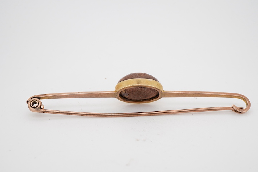 A boulder opal brooch, early 20th century, the bar brooch set with a cabochon boulder opal measuring approximately 16.9 x 12 x 9.5mm, mounted in gold, gross weight 8 grams